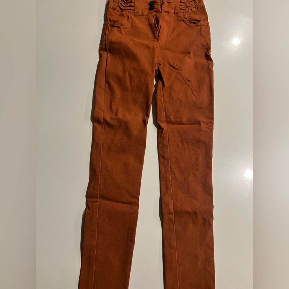 New, Never worn Pumpkin colored stretchy jeans